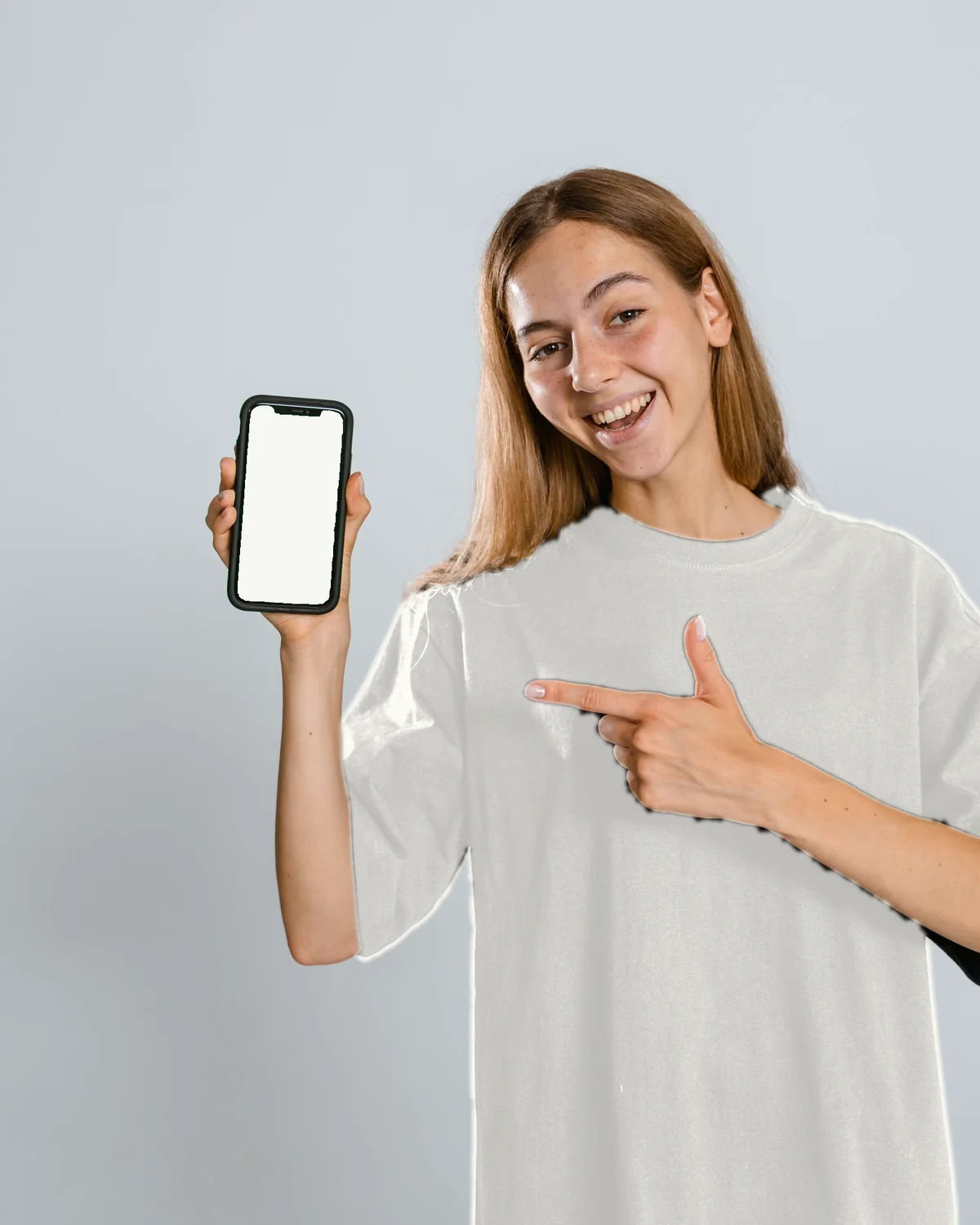 A woman holding her phone, calm, looking at the camera